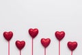 Stock photo of red hearts with red stick on a white background and a space for text Royalty Free Stock Photo