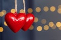 Stock photo of red plastic hearts hanging with an unfocused background Royalty Free Stock Photo