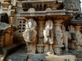 Stock photo of ruined ancient sculpture of Hindu trinity god sitting on elephant, idol carved out off gary color granite sunlight Royalty Free Stock Photo