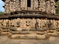 Stock photo of ruined ancient sculpture of Hindu trinity god sitting on elephant, idol carved out off gary color granite sunlight Royalty Free Stock Photo