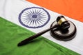 Stock photo showing Indian low and jurisdiction - Indian national flag or tricolour with wooden gavel showing concept of law in In