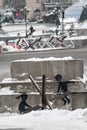 A boy and a girl swing on an anti-tank hedgehog - Banksy graffiti in Kyiv, Ukraine