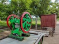 Stock photo of side view of green and red color manual sugarcane juice maker or extractor machine at road side of the Indian Royalty Free Stock Photo