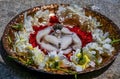 Stock photo of a silver shivlinga which is icon of lord shiva snake above shivlinga, being worshiped flowers and cotton garland on