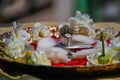 Stock photo of a silver shivlinga which is icon of lord shiva snake above shivlinga, being worshiped flowers and cotton garland on