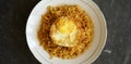 Stock photo tasty fried noodle with fried egg on a white plate and a stone pad