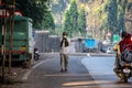 Stock photo of 50 to 60 year old grandpa or Indian old man walking on empty asphalt road in