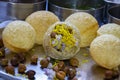 Stock photo of traditional pupular Indian street food or snacks panipuri. stuffed puri with onion black chickpeas and yellow shev