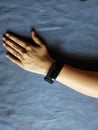 Stock photo of a women hand wearing black color smart watch,rectangle shape dial with blue color Royalty Free Stock Photo