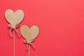 Stock photo of wooden hearts on a red background with a space for text