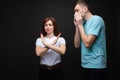 Young woman with stop gesture and a sneezing man. Royalty Free Stock Photo