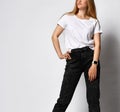 Stock photo of young, fit and sexy woman in jeans and white top  on white. Royalty Free Stock Photo