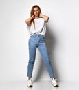 Stock photo of young, fit and sexy woman in jeans and white top isolated on white Royalty Free Stock Photo