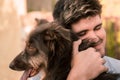 Stock photo of a young man hugging a brown dog, friendly concept animal, best friends