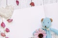 Stock Photography flat lay vintage white painted wood table purple flower petals bear doll heart craft