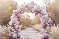 Pastel balloon arch over cobbled path in garden setting Royalty Free Stock Photo