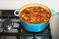 Stock simmering gently in a pot on a gas stove