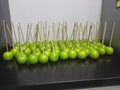 A stock of sweet candied apples on sticks ready to serve