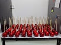 A stock of sweet candied apples on sticks ready to serve