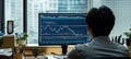 Stock trader analyzing cryptocurrency chart data on computer in office