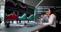 Stock trader analyzing market data on multiple monitors with financial graphs Royalty Free Stock Photo