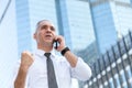 stock trader, investor, businessman talking on the mobile phone as happy after getting good news about profit on investment Royalty Free Stock Photo