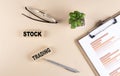 STOCK TRADING text on wooden block with chart and glasses, business concept Royalty Free Stock Photo