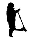 Silhouette of a boy riding scooter Royalty Free Stock Photo