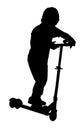 Silhouette of a boy riding scooter Royalty Free Stock Photo