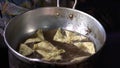 Stock Video Footage hdv Cooking Thai food outdoors, fried boiling oil, pies