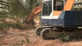 Stock Video Footage 1920x1080 Excavator on a construction site equates land clearing a building site, excavator bucket working.