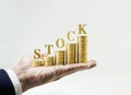 Stock word with money coin stacked growing on Businessman hand. Royalty Free Stock Photo