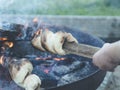 Stockbrot or twisted campfire stick bread over flames