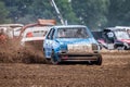 Stockcar drives on a dirty track at a Stockcar challenge. Royalty Free Stock Photo