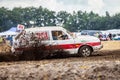 Stockcar drives on a dirty track at a Stockcar challenge. Royalty Free Stock Photo