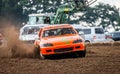 Stockcar drives on a dirty track at a Stockcar challenge. Royalty Free Stock Photo