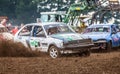 Stockcar drives on a dirty track at a Stockcar challenge. Royalty Free Stock Photo