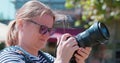 Stocker woman, tourist looking at camera, photographing hair fluttering in wind