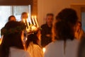 Lucia parade with singing girls and boys in white dresses holding candles. Traditional celebration of the suffering of saint