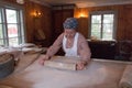 A woman making rustic thin bread with rolling pin, Skansen Open-Air Museum, Stockholm, Sweden