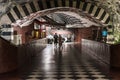 Stockholm, Sweden - Decorated interior of the underground metro with a young couple walking through the isle