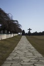 Stockholm / Sweden - 14 Febrary 2018: Road leading up to the granite cross, at the UNESCO world heritage The Woodland Cemetery Royalty Free Stock Photo