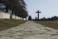 Stockholm / Sweden - 14 Febrary 2018: Road leading up to the granite cross, at the UNESCO world heritage The Woodland Cemetery Royalty Free Stock Photo