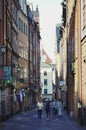 Tourists walking on the old cobble streets in the market in Gamla Stan, the old town of Stockholm in Sweden