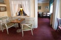 Curtains and retro armchairs without visitors in classic interior cafe inside old house