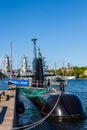 Swedish submarine and warships in the background moored at the quay.