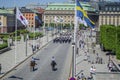 Stockholm, Sweden - June 15, 2019 Group of uniformed national guard marching on the street followed by two horsemen in Stockholm