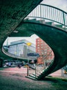 Curved staircase on concrete bridge.