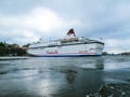 Stockholm / Sweden - May 15 2011: Viking Line cruise ship Cinderella with flag of Sweden turning and leaving port of Stockholm Royalty Free Stock Photo