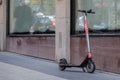 Voi, electric rental kick scooter on the sidewalk.